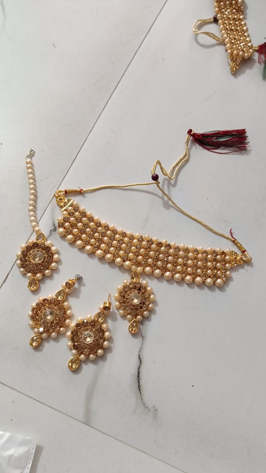 Gold-plated long traditional pearls necklace set with earrings and maang tika for women and girls.