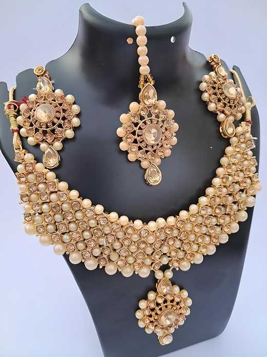 Gold-plated long traditional pearls necklace set with earrings and maang tika for women and girls.